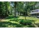 Large, lush backyard with mature trees and landscaping at 608 Misty Isle Pl, Raleigh, NC 27615