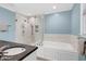 Modern bathroom featuring a glass-enclosed shower and a soaking tub at 608 Misty Isle Pl, Raleigh, NC 27615