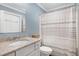 Bathroom featuring a light blue wall, granite countertop, and striped shower curtain at 608 Misty Isle Pl, Raleigh, NC 27615