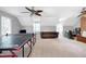 Spacious bonus room with ping pong table, sitting area, and natural light at 608 Misty Isle Pl, Raleigh, NC 27615