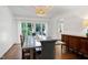 Bright dining room with modern table and chairs, plus a view to the backyard at 608 Misty Isle Pl, Raleigh, NC 27615