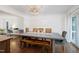 Dining room with a large table, bench, and chairs, and view to a desk area at 608 Misty Isle Pl, Raleigh, NC 27615