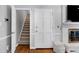 Inviting foyer featuring hardwood floors, a fireplace, and staircase leading to the upper level at 608 Misty Isle Pl, Raleigh, NC 27615