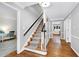 Elegant foyer with hardwood floors, staircase, and a view into adjacent rooms, creating a warm and inviting entrance at 608 Misty Isle Pl, Raleigh, NC 27615