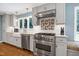 Kitchen featuring gray cabinets, stainless steel appliances, and granite countertops at 608 Misty Isle Pl, Raleigh, NC 27615
