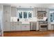 Kitchen featuring gray cabinets, stainless steel appliances, and a farmhouse sink at 608 Misty Isle Pl, Raleigh, NC 27615