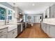 Kitchen featuring gray cabinets, stainless steel appliances, and hardwood floors at 608 Misty Isle Pl, Raleigh, NC 27615