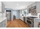 Updated kitchen with stainless appliances, granite countertops, and hardwood floors at 608 Misty Isle Pl, Raleigh, NC 27615