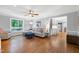 Bright living room featuring hardwood floors, a ceiling fan, and neutral-colored furniture at 608 Misty Isle Pl, Raleigh, NC 27615