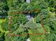 Aerial view outlining the property lines of a home amidst dense trees, showcasing its estate size at 608 Misty Isle Pl, Raleigh, NC 27615