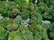 Aerial view of property lines encompassing a secluded home surrounded by a lush forest at 608 Misty Isle Pl, Raleigh, NC 27615