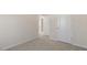 Clean bedroom with neutral carpet, white trim, and a view to the doorway and closet at 62 Cheyenne Dr, Clayton, NC 27520