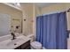 Full bathroom with vanity, toilet, and shower with blue shower curtain at 62 Mountain Laurel Ln, Four Oaks, NC 27524