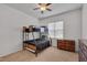 A cozy bedroom featuring a bunk bed, ceiling fan, and two wooden dressers at 62 Mountain Laurel Ln, Four Oaks, NC 27524
