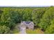 Charming home exterior with inviting entrance, lush landscaping, attached garage and solar panels at 62 Mountain Laurel Ln, Four Oaks, NC 27524