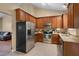 Kitchen featuring stainless steel appliances, granite countertops, and wooden cabinets at 62 Mountain Laurel Ln, Four Oaks, NC 27524