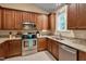 Well-equipped kitchen boasting granite countertops, stainless steel appliances, and wood cabinetry at 62 Mountain Laurel Ln, Four Oaks, NC 27524