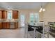 Kitchen features stainless steel appliances, granite countertops, eat-in area, and wooden cabinets at 62 Mountain Laurel Ln, Four Oaks, NC 27524