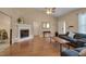 Living room featuring hardwood floors, vaulted ceilings, and a corner fireplace at 62 Mountain Laurel Ln, Four Oaks, NC 27524