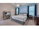Comfortable bedroom with blue accent walls, large windows, and ample closet space at 62 Mountain Laurel Ln, Four Oaks, NC 27524