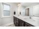 Bathroom featuring a double vanity with white countertops, framed mirrors, and ample lighting at 645 Longstanton Ave, Zebulon, NC 27597