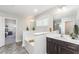Bathroom with a white vanity, a large mirror, a separate tub, and a walk-in shower at 645 Longstanton Ave, Zebulon, NC 27597
