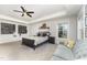 Well-lit bedroom with neutral walls, a ceiling fan, and a cozy couch at 645 Longstanton Ave, Zebulon, NC 27597