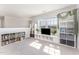 Large upstairs bonus room with natural light, shelving, and a mounted television at 645 Longstanton Ave, Zebulon, NC 27597