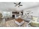 Open-concept living area with a modern ceiling fan, a gray sofa, and access to the kitchen at 645 Longstanton Ave, Zebulon, NC 27597
