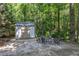 Backyard with a shed, fire pit and lush landscaping with trees at 6509 Conaway Ct, Wake Forest, NC 27587
