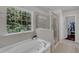 Bathroom featuring a soaking tub, a glass shower, and a large window with natural light at 6509 Conaway Ct, Wake Forest, NC 27587