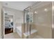 Bright bathroom showcasing a large glass shower with a built-in seat, tub, and view into the main bedroom at 6509 Conaway Ct, Wake Forest, NC 27587
