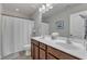 Bathroom featuring a double sink vanity with wooden cabinets and a large mirror at 6509 Conaway Ct, Wake Forest, NC 27587