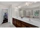 Bright bathroom with double vanity, tile flooring, and a glass-enclosed shower at 6509 Conaway Ct, Wake Forest, NC 27587