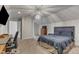 Large bedroom featuring a ceiling light, a desk with chair, and a bed with a gray headboard at 6509 Conaway Ct, Wake Forest, NC 27587
