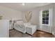 Bright bedroom filled with a bed, dresser, rug, and a window allowing natural light to illuminate the space at 6509 Conaway Ct, Wake Forest, NC 27587