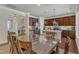Dining room features an open concept to the kitchen and large glass top table with seating for eight at 6509 Conaway Ct, Wake Forest, NC 27587