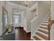 Inviting foyer boasts hardwood floors, staircase and natural light from the front door at 6509 Conaway Ct, Wake Forest, NC 27587