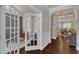 Elegant hallway with hardwood floors, arched doorways, and access to a home office at 6509 Conaway Ct, Wake Forest, NC 27587