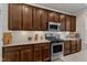 Modern kitchen featuring stainless steel appliances, granite countertops, and custom cabinetry at 6509 Conaway Ct, Wake Forest, NC 27587