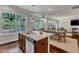 Bright open kitchen with granite counters and an island with stainless steel appliances and hardwood floors at 6509 Conaway Ct, Wake Forest, NC 27587