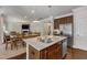 Open kitchen with stainless steel appliances, granite countertops, and hardwood floors at 6509 Conaway Ct, Wake Forest, NC 27587