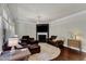 Bright living room with hardwood floors, fireplace, and comfortable leather seating at 6509 Conaway Ct, Wake Forest, NC 27587