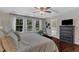 Well-lit main bedroom features large windows, hardwood floors, and neutral decor at 6509 Conaway Ct, Wake Forest, NC 27587
