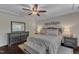 Comfortable main bedroom with decorative ceiling, hardwood floors, and soft lighting at 6509 Conaway Ct, Wake Forest, NC 27587