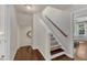 Well-lit stairway with hardwood floors, carpeted steps, and decorative trim at 6509 Conaway Ct, Wake Forest, NC 27587