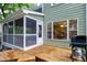 Outdoor entertaining area with a grill and kitchen view from the wooden porch at 709 Bonhurst Dr, Holly Springs, NC 27540