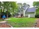 Expansive backyard with a screened porch, wooden deck, lush green lawn, and inviting patio area at 709 Bonhurst Dr, Holly Springs, NC 27540