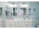 Bathroom featuring double vanity sinks, stylish mirrors, and neutral paint at 709 Bonhurst Dr, Holly Springs, NC 27540