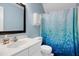 Bathroom featuring a white vanity, mosaic-patterned shower curtain, and blue walls at 709 Bonhurst Dr, Holly Springs, NC 27540